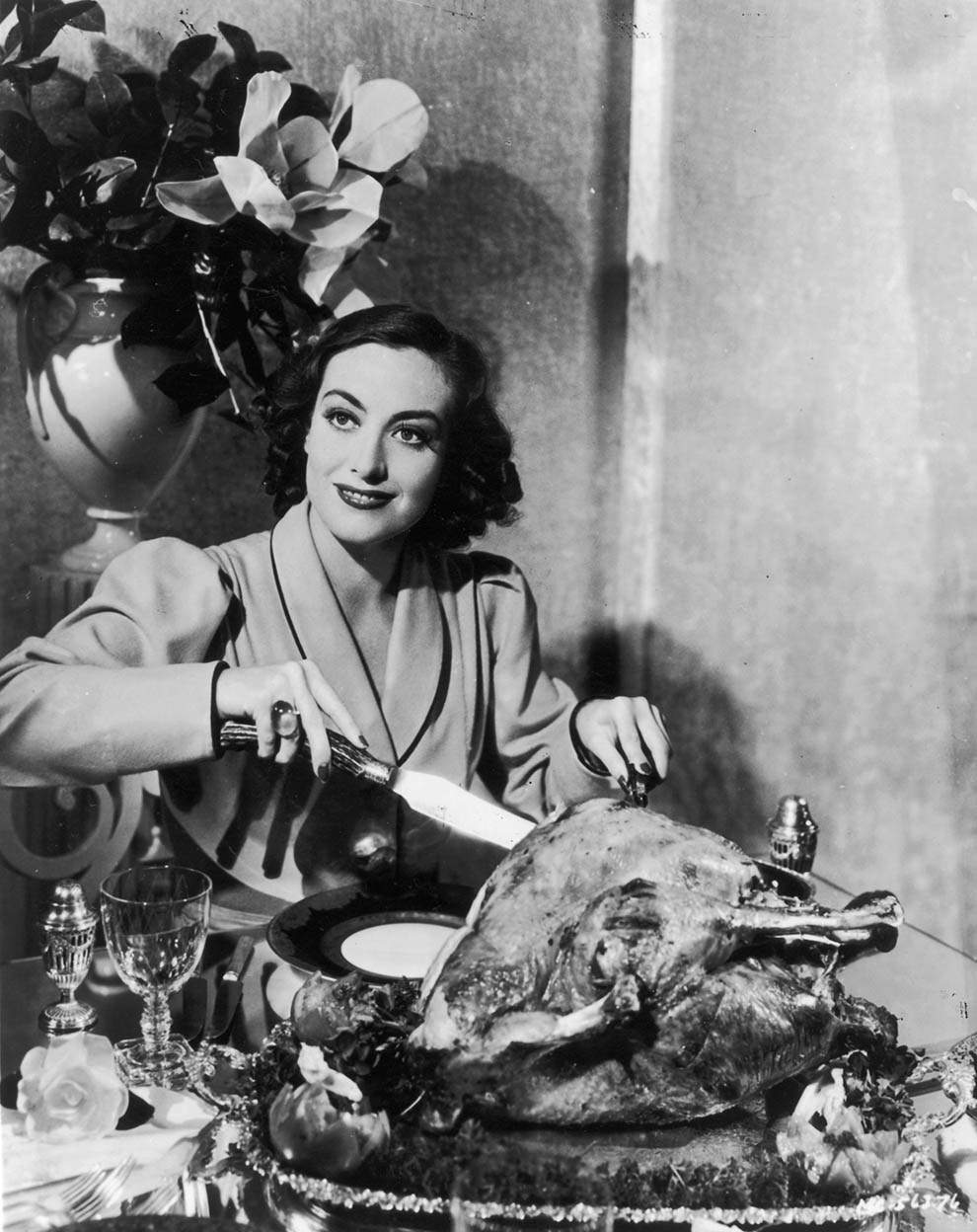 #15 Joan Crawford carving a turkey. For a publicity shot,1930.
