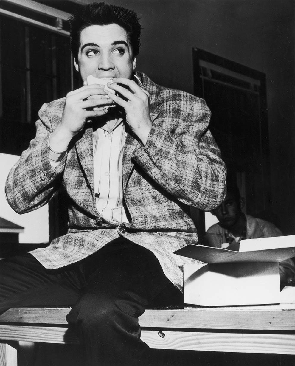 #5 Elvis Presley eating a sandwich. Memphis, Tennessee, 1958.