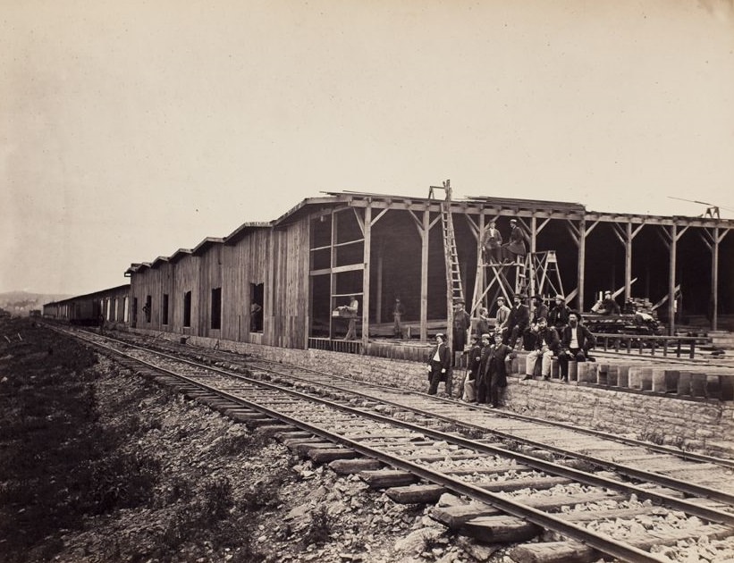 #15 Men along railroad in front of warehouses under construction, 1865