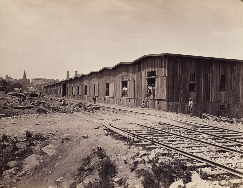 #44 Warehouses in a railroad yard, 1865
