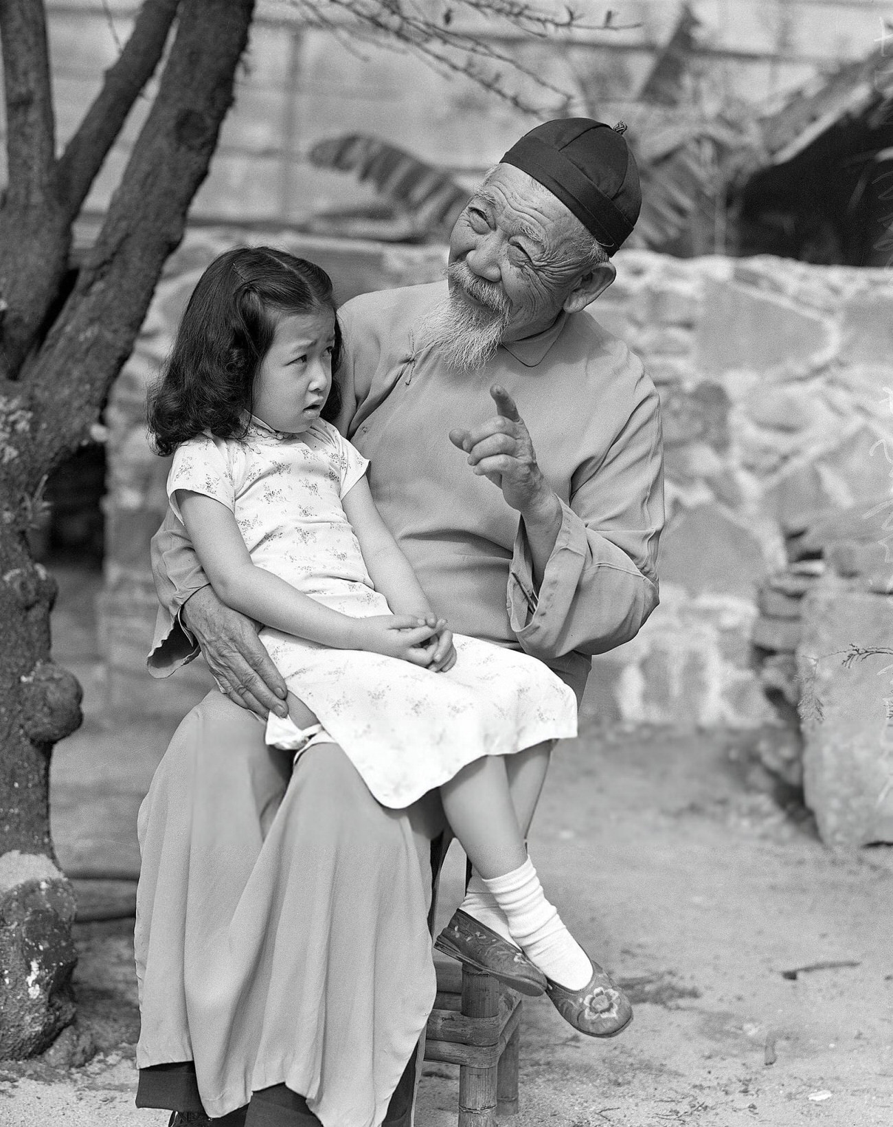 #3 Tom Yuen tells a story to Sylvia Wong during Chinese New Year celebrations in Los Angeles, 1942.