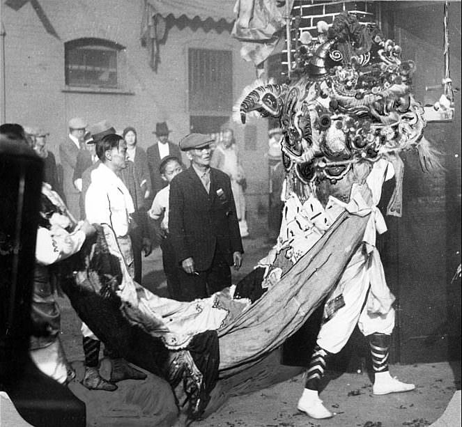 #6 The Chinese Lion collecting gifts during New Year’s celebrations in Los Angeles’ Chinatown, 1930.