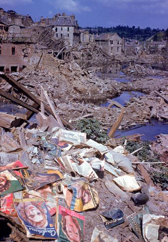 #8 Magazines scattered among the rubble of the heavily bombed town of Saint-Lô, Normandy, France, summer 1944