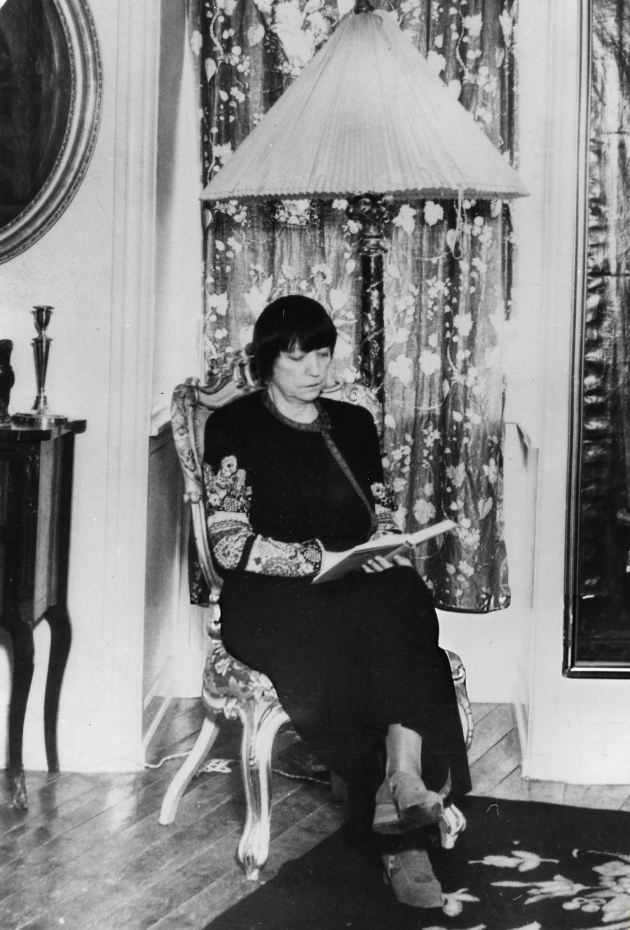 #129 Asta Nielsen reading in her apartment, Denmark