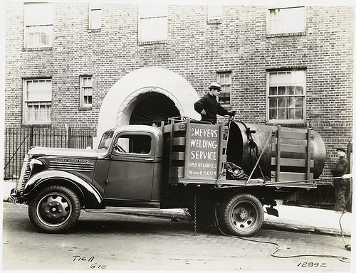 Model T 16A – G12 Men working from the truck for A.C. Meyers Welding Service.