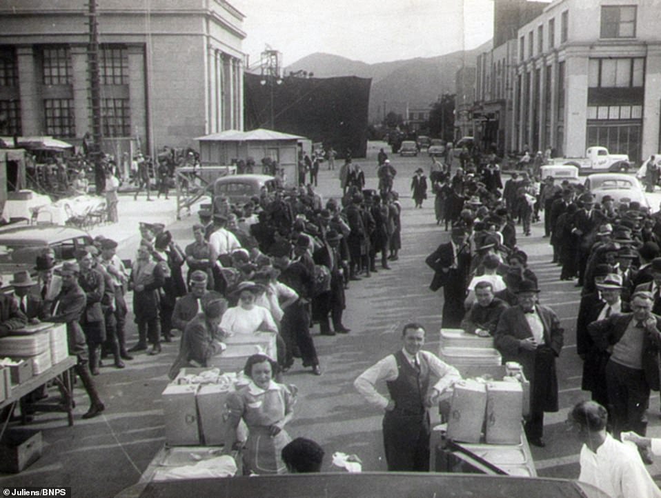 Extras on set lining up to receive lunch during the shooting of one of the film’s scenes.