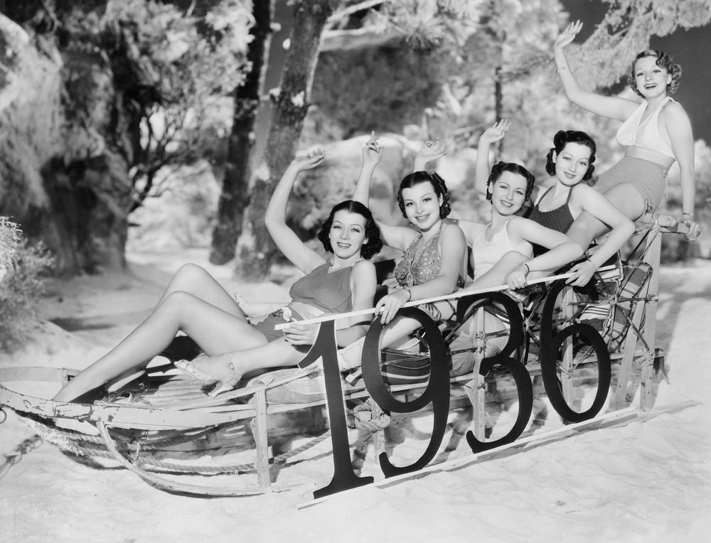 #60 A group of women enjoy a New Year’s sledding party.