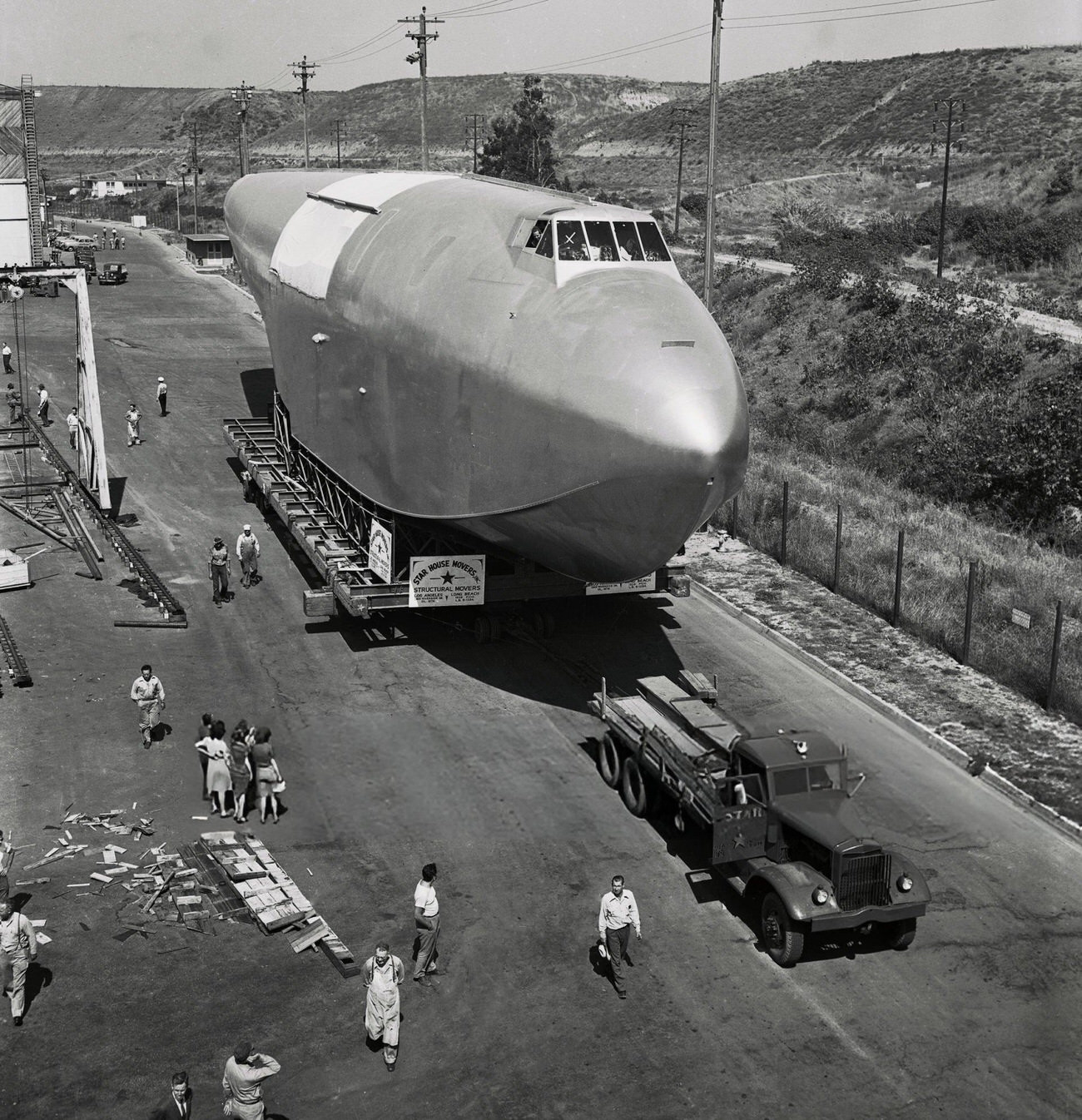 The fuselage of Howard Hughes’ Spruce Goose leaving the hangar, 1940s.