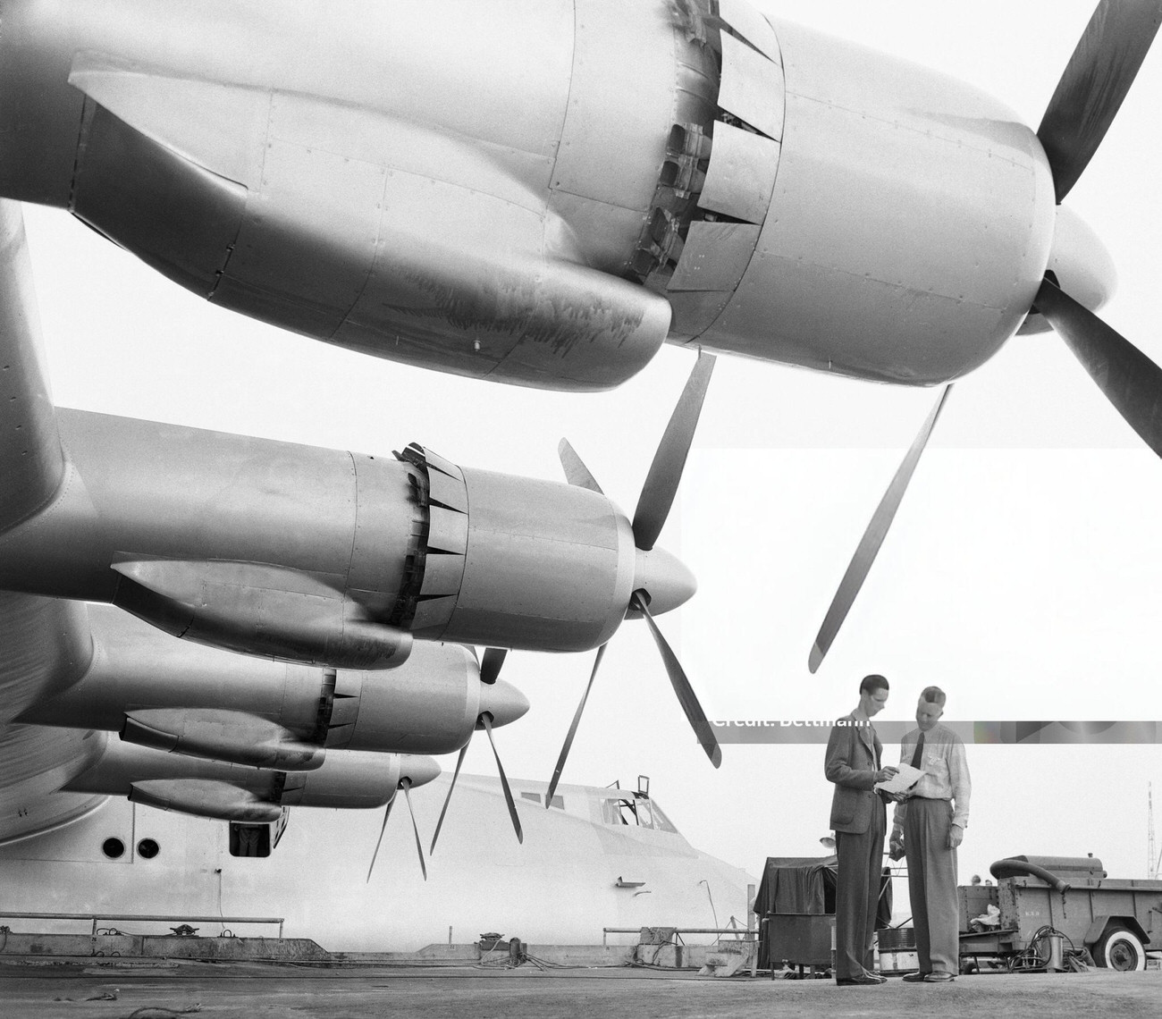 Two men dwarfed by the Spruce Goose’s wing engines, 1947.