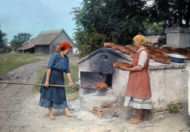#14 Two peasant women bake bread with an old-fashioned stove in Hungary, June 1932.