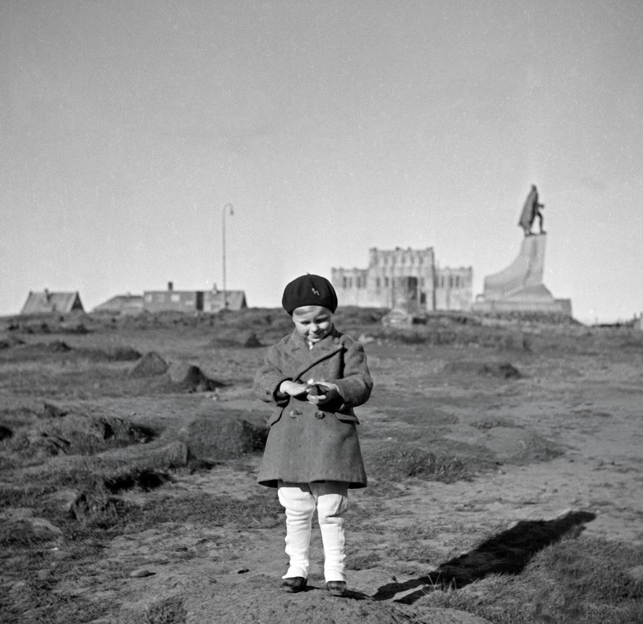 #14 A young boy in front of the Ingolfur Arnarson statue in Reykjavik, Iceland, 1930s.
