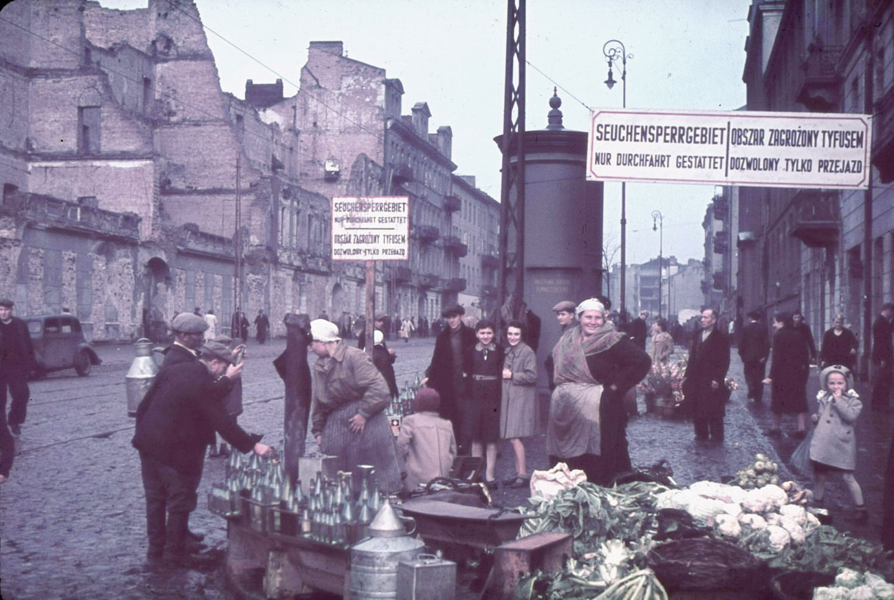 #12 Warsaw, Nazi-occupied Poland, 1940. The signs read, “Typhus area. Passage permitted only while traveling.”