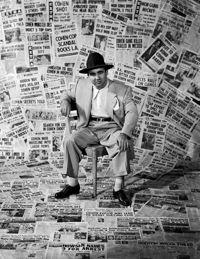 #2 Gangster Mickey Cohen sits amid the front pages of newspapers that helped make him the city’s’ most infamous citizen, Los Angeles, 1949.