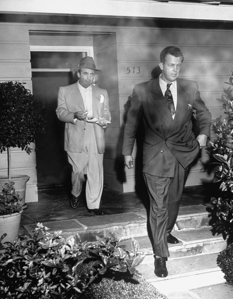 #6 Angry and hungry, Mickey eats sandwich as he leaves home with cop who arrested him for cursing other officers. Mickey called arrest persecution.