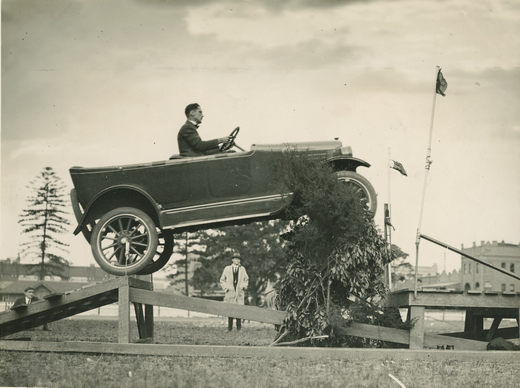 Overland car jumping a fallen bridge in a promotional stunt, 1920 – 1929