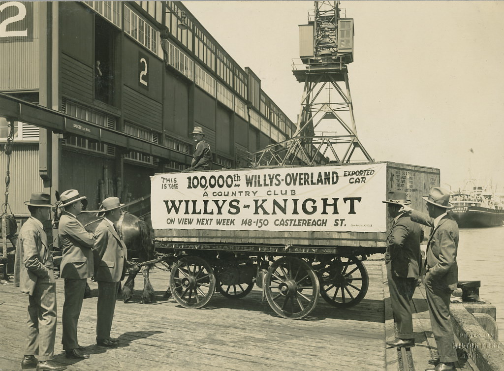 Horse and cart on wharf with crate containing the 100,000th Willys-Overland exported car, 1920 – 1929