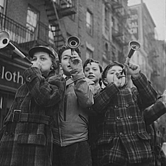 #31 Children blowing horns on Bleecker Street on New Year’s Day, 1943.