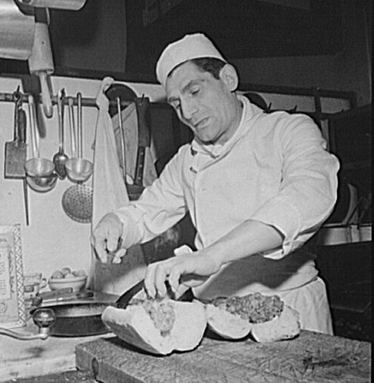 #11 Making meatball subs for takeout customers during a party.