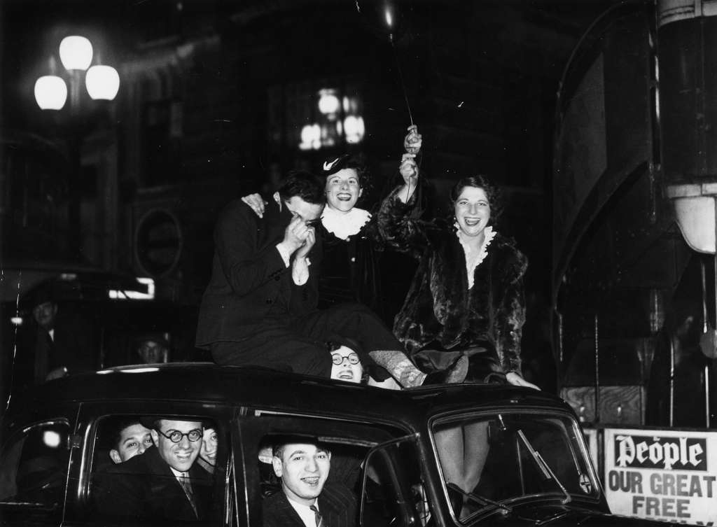 #44 Friends celebrating the arrival of 1936 on a car roof in London.