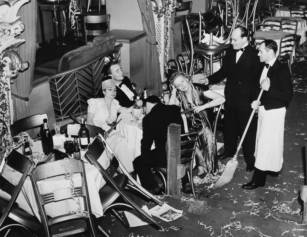 #14 Employees of the Diamond Horseshoe cleaning up after a New Year’s Eve party, New York City, 1940.