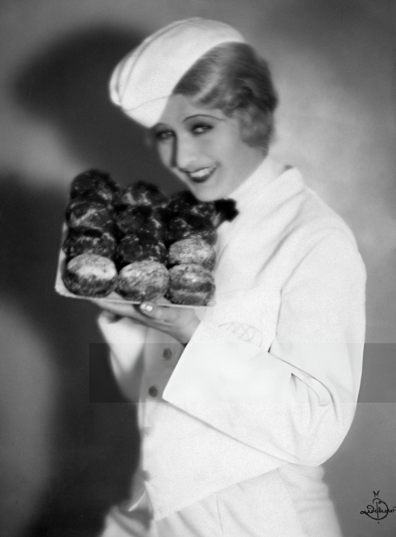 #31 Lee Parry presenting doughnuts for New Year’s Eve, 1920s.
