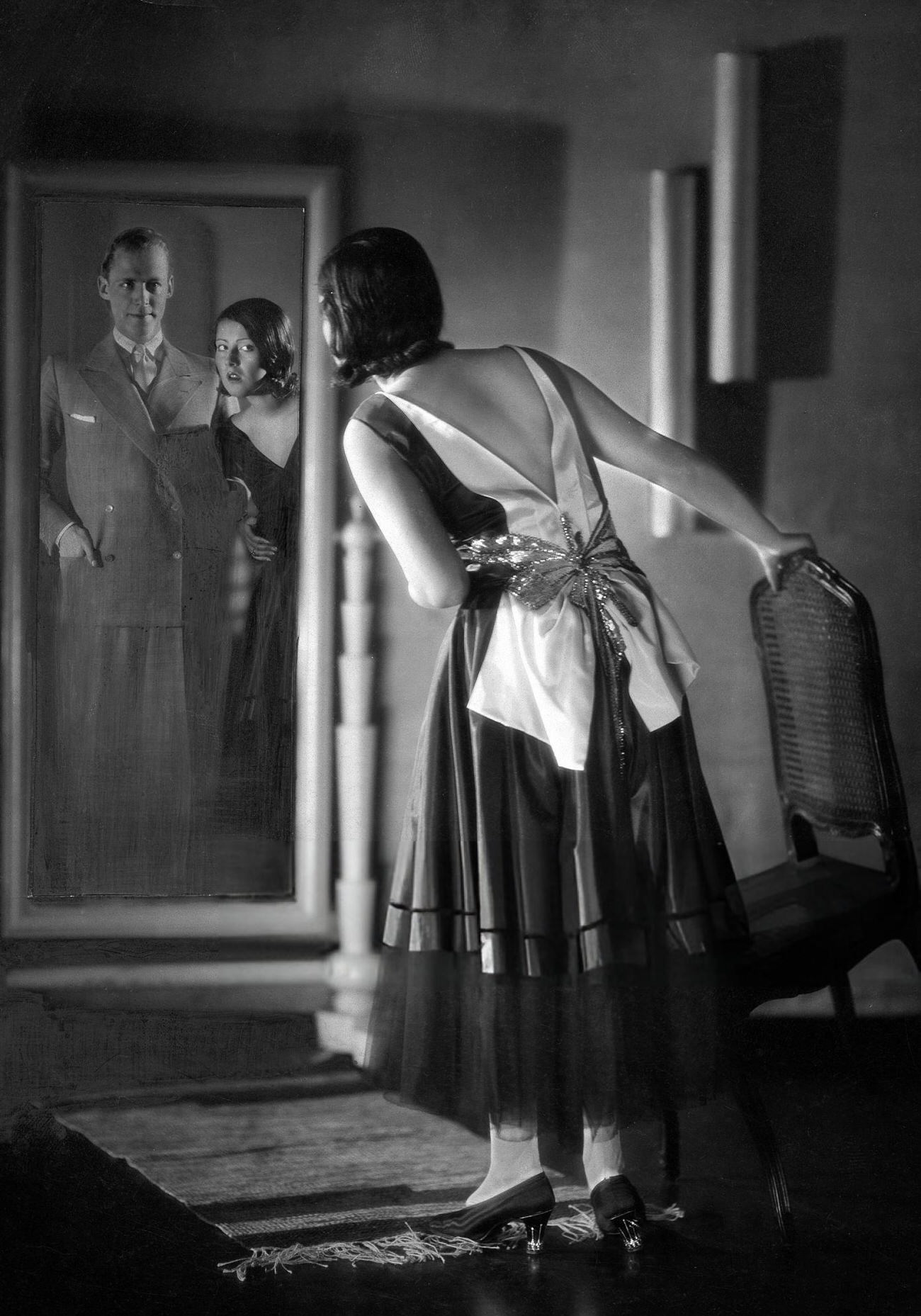 #38 A woman looking in a mirror on New Year’s Eve, 1929.