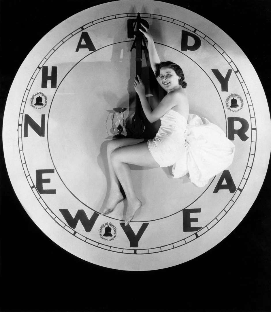 A woman sitting on a watch at twelve o’clock on New Year’s Eve, 1928.