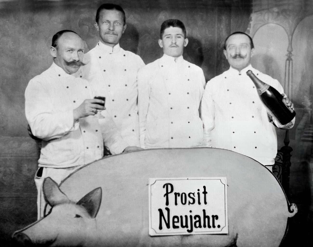 #11 Four men toasting the New Year with a cardboard pig, 1920s.