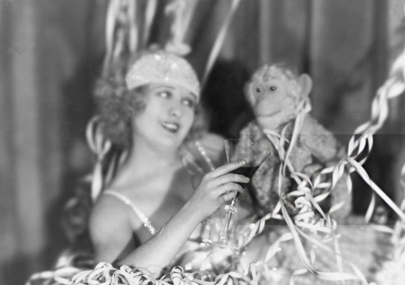 #21 Lee Parvy toasting with a plush monkey on New Year’s Eve, 1927.