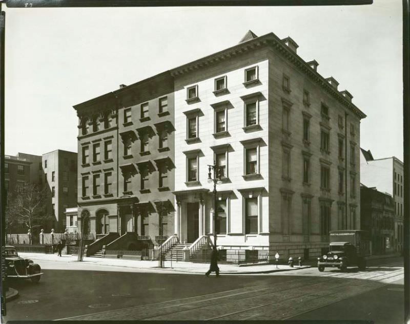 #33 Three large row houses, including one of marble (#8) and traffic on Fifth Ave. and 8th St., and trolley tracks in 8th St.