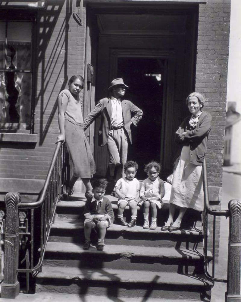 #35 Jay Street, No. 115, Brooklyn. Three generations of African Americans on stoop of brick home with iron rails on steps.