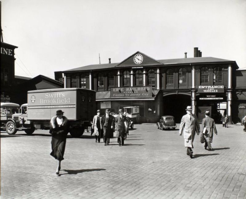 #50 Ferry, Chambers Street, Manhattan. Trucks, wagon, car and pedestrians in front of Erie Railroad ferry terminal.