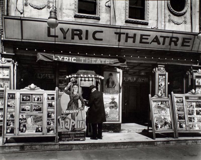 #52 Box office and marquee of Lyric theater, man purchusing ten cent ticket, posters, including life-size cutout of Charlie Chaplin on display.