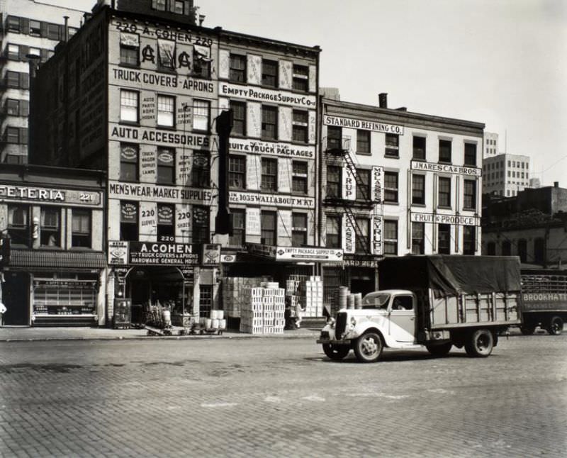 #54 217-221 West Street, Manhattan. 2, 3, and 4-story buildings with a cafeteria, produce market, hardware store, package supply store and other businesses.