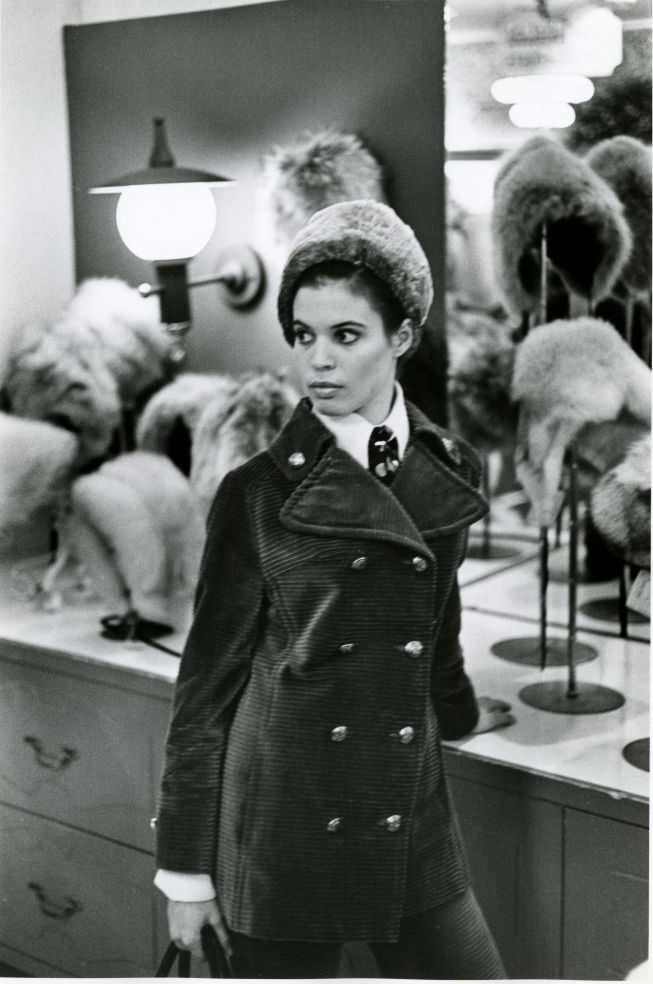 #49 Woman in front of hat display.