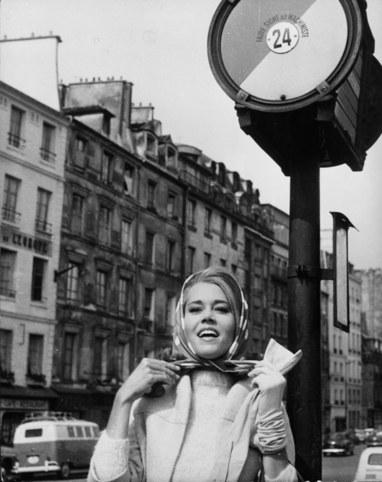 #19 On a visit to Paris, Jane Fonda demonstrates the single-gloved scarf-tying technique, a very difficult French move to master, 1963.