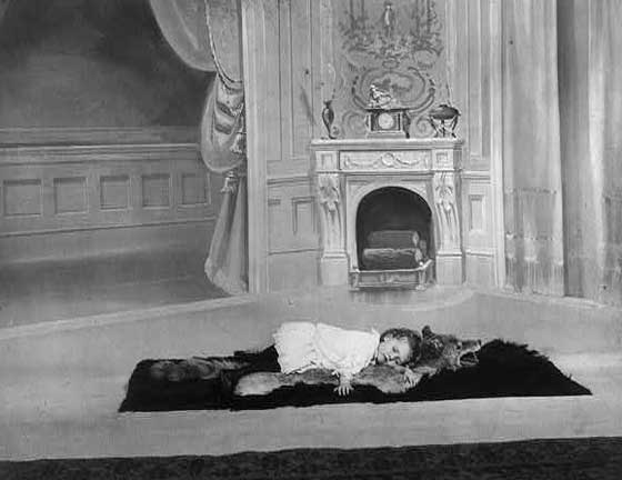 #21 A little girl napping on a wolfskin rug, 1900.