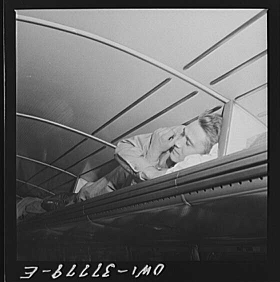 #9 A soldier napping in a Greyhound bus luggage rack, 1943.