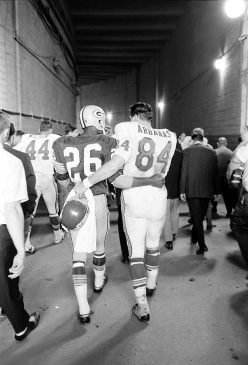 The Packers’ Herb Adderley and Kansas City’s tight end Fred Arbanas head to the lockers after Green Bay’s 35-10 victory in Super Bowl I, Los Angeles, 1967