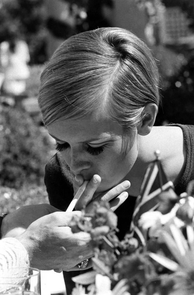 #10 Twiggy lights up at a party thrown for her in Beverly Hills, 1967.