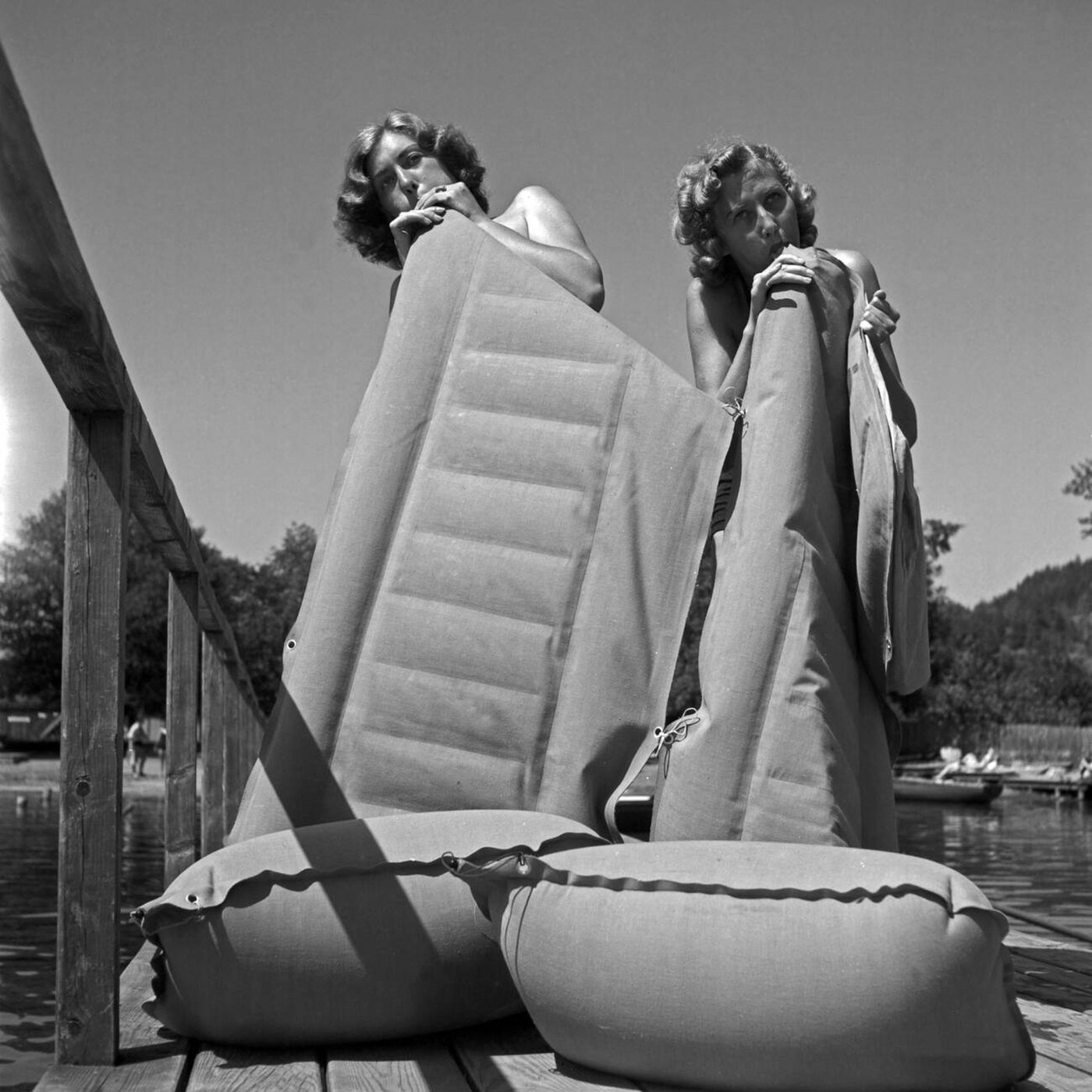 #21 Bathgoers inflating air mattresses at an Austrian lake, 1930s.