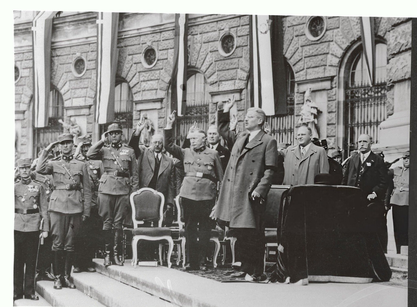 #52 Chancellor Kurt Schuschnigg saluting during a parade in Vienna.