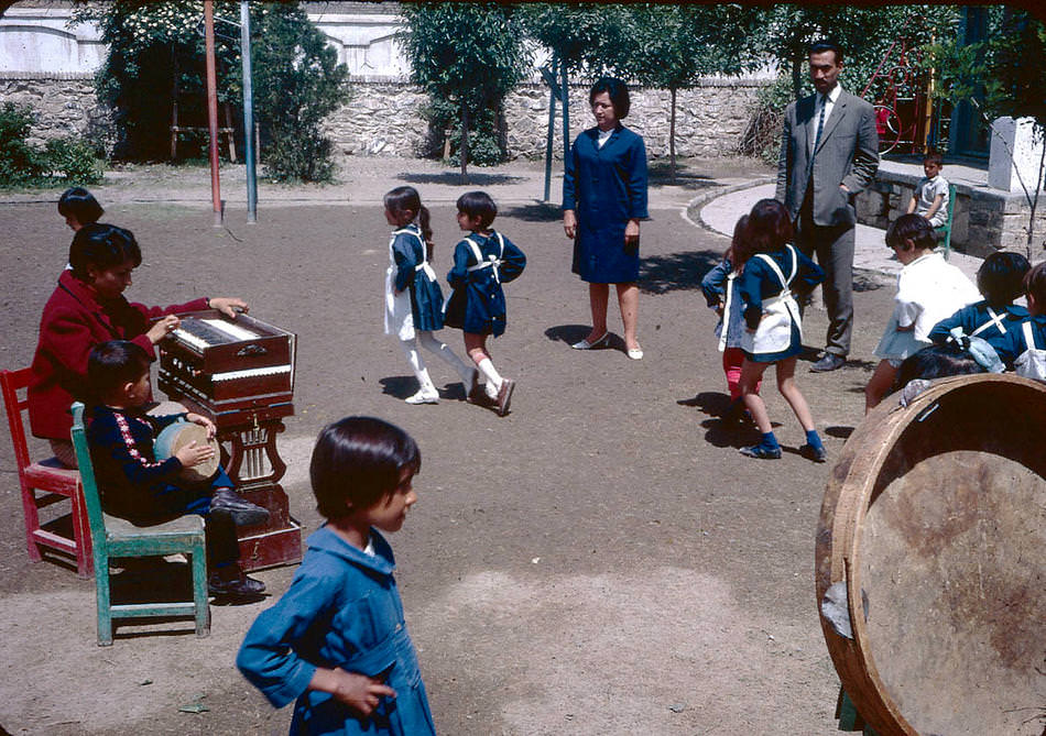 #10 Young students dancing to music on a school playground.