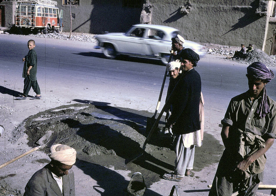 #23 Afghan workers make a street repair in Kabul.