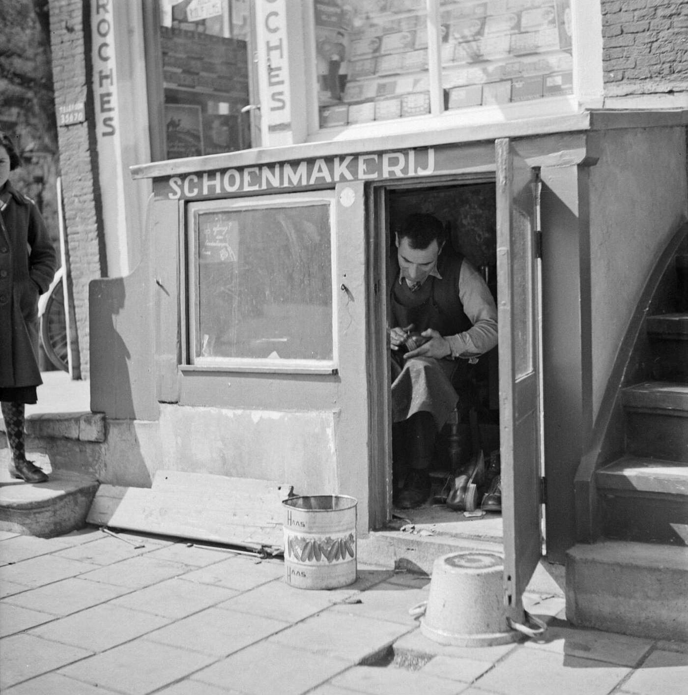 #12 A shoemaker in his workshop, 1930s.