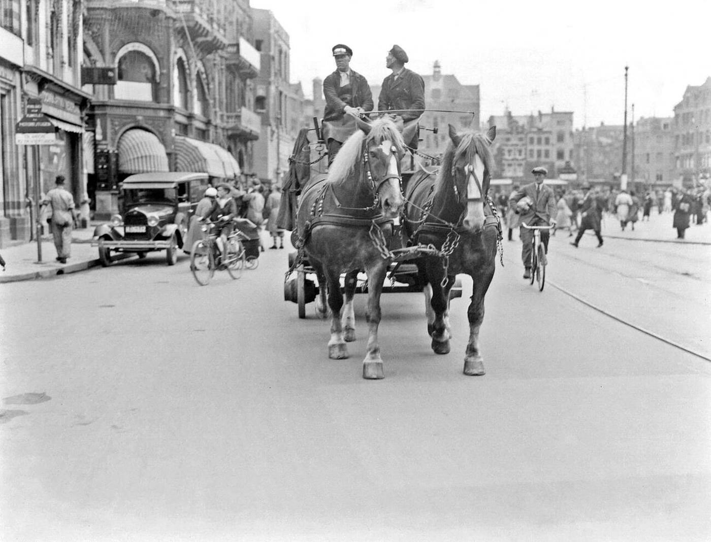 #13 Two horses in front of the Heineken beer wagon on the Rokin, undated.