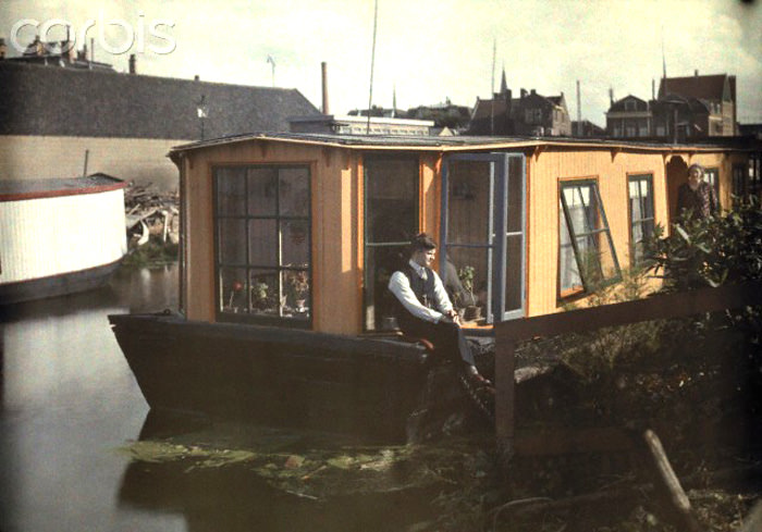 #3 A man relaxes outside his houseboat in Haarlem, 1930s.