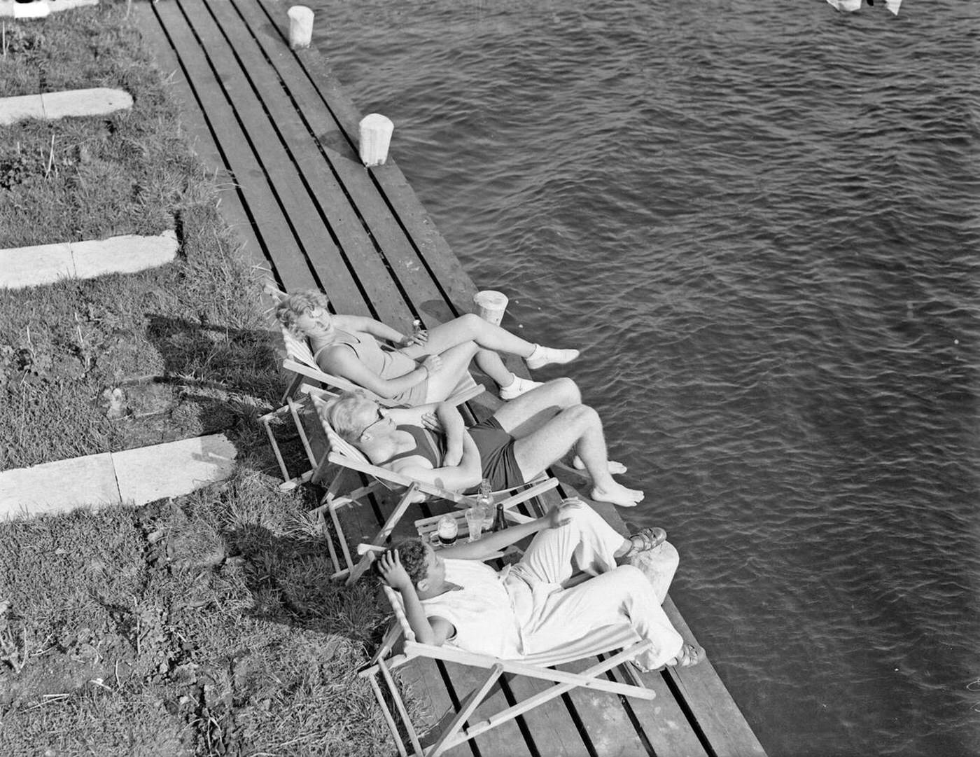 #34 Model Eva Waldschmidt, model Grummels and unknown woman in sun loungers on the banks of the Westeinderplassen, 1930s.