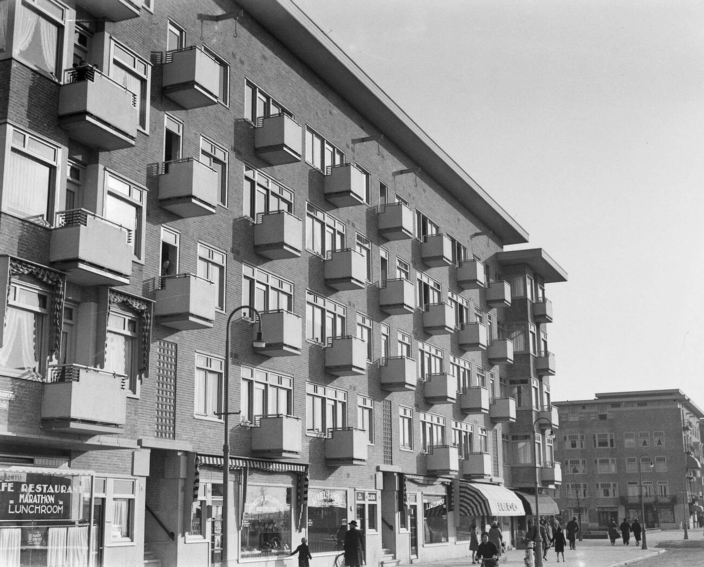 #8 Facade view of homes and shops on Stadionplein in Amsterdam South, 1930s.