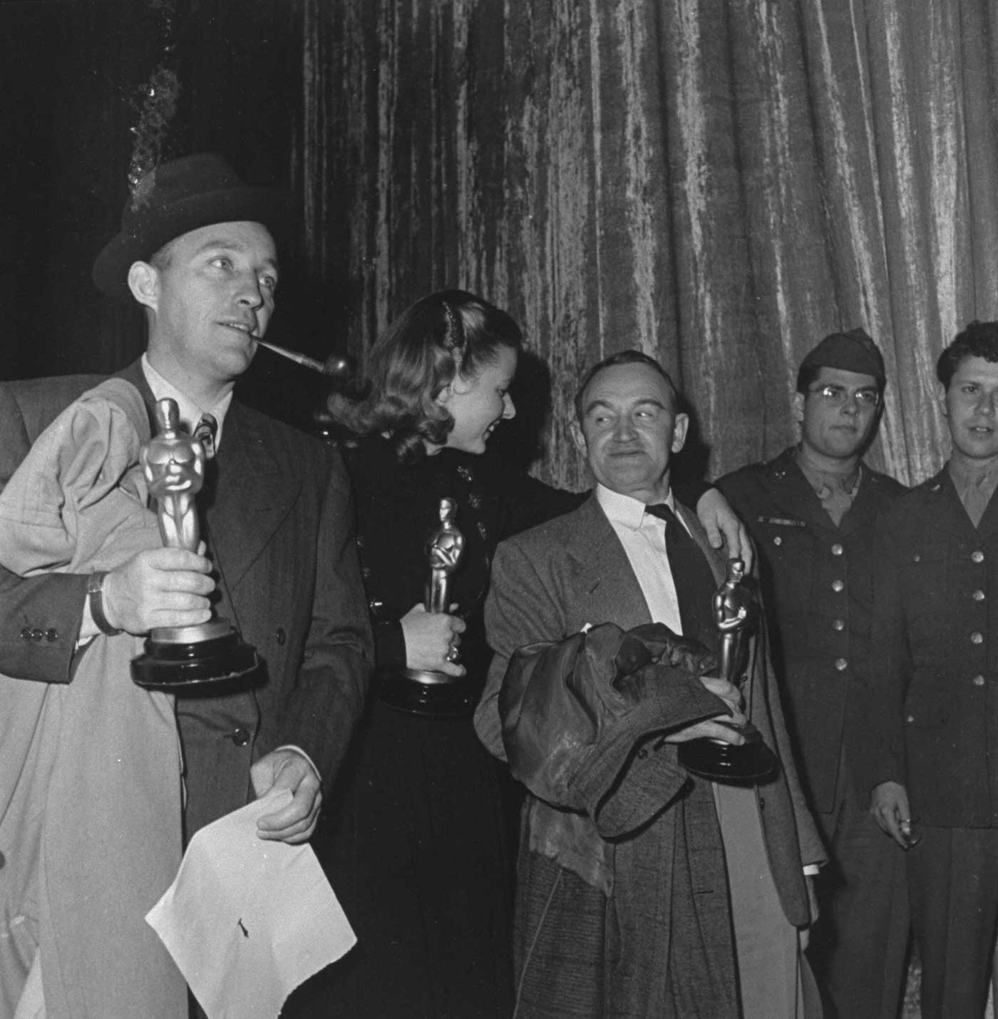 #9 Bing Crosby (Going My Way), Ingrid Bergman (Gaslight) and Barry Fitzgerald (Going My Way) with their Oscars, 1945.